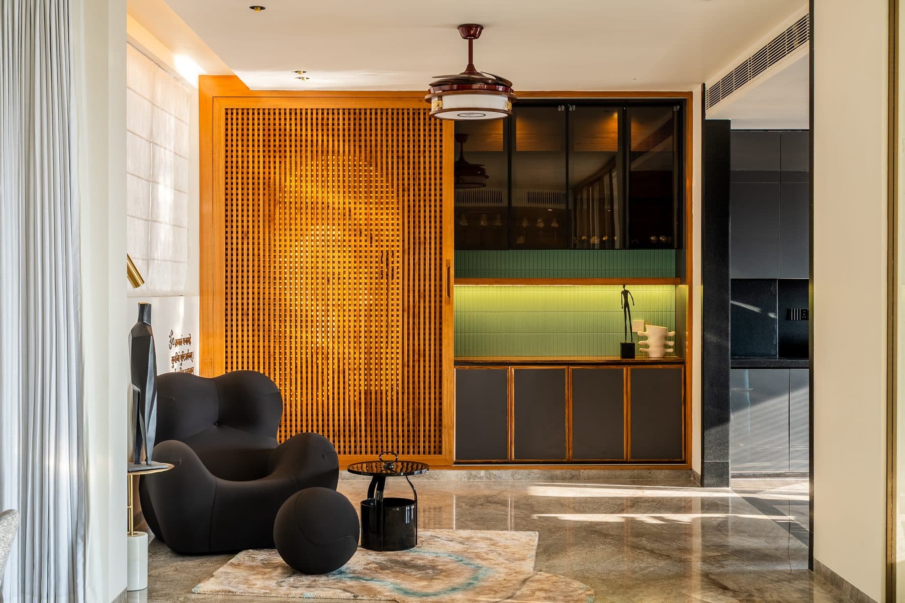 Timber batten screen slid across the pooja arch to reveal a bar with a lit green-tiled backsplash